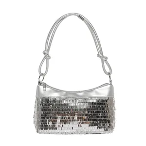 Silver sequin shoulder bag with thick knotted rope straps on a white background