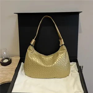 Elegant gold woven faux leather tote bag displayed in a luxury gift box for women