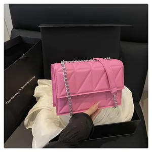 Chic quilted crossbody bag in bright pink shown with elegant black gift packaging