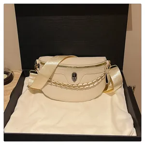 Detail of off-white leather half-moon bag with 3D skull metal stud and chain strap