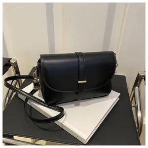 Detail view of premium black leather shoulder bag with gold hardware and fine stitching