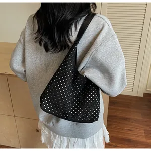Chic black hobo bag with sparkling silver rhinestones worn over the shoulder