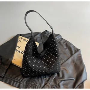 Detail of black crescent hobo bag with sparkling silver rhinestone embellishments