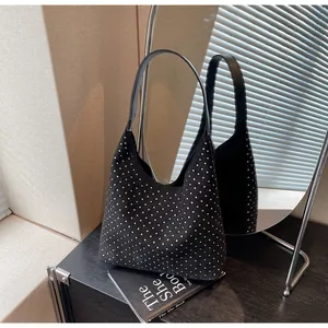 Detail of black rhinestone hobo bag with sparkling crystals and leather shoulder strap