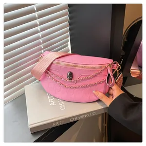 Detail of pink leather chest bag with skull embossing and silver metal chain accessory