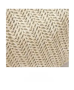 Close-up of the intricate V-shaped straw weave pattern on a beige summer bucket bag