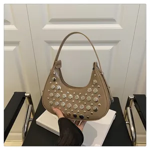 Detail of khaki crescent underarm bag with silver rivet studs and smooth leather texture