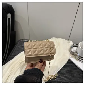 Detailed close-up of khaki quilted mini crossbody bag with elegant golden chain strap