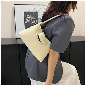 Detail of cream woven shoulder bag with mini round coin purse and textured synthetic leather