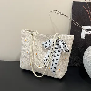 Minimalist straw tote bag with daisy embroidery and polka dot ribbon for summer style