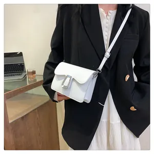 Close-up of white minimalist square crossbody bag featuring a silver metal buckle closure