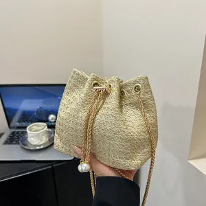 Summer woven bucket bag with drawstring closure and golden metal chain strap