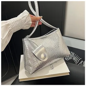 Detailed view of silver shoulder bag with woven texture and metallic leather finish