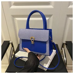 Detail of blue and white striped texture with golden horseshoe buckle on leather handbag
