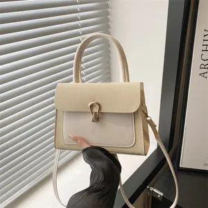 Chic beige textured crossbody bag with horsebit metal buckle and top handle for women