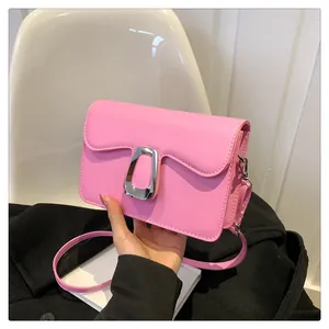 Close-up of fuchsia square bag with silver abstract hollow metal buckle and PU leather strap