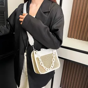 Detail of woven straw and white leather crossbody bag with chunky plastic chain