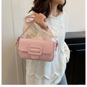 Detailed close-up of pink vintage baguette bag with large matching square buckle