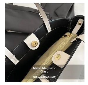 Detail of magnetic buckle closure and inner zipper pocket on a contrast tote bag