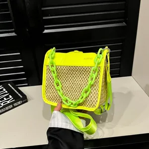 Detail of woven chain handbag featuring neon green trim and woven straw texture finish