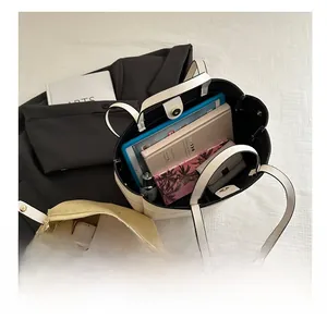 Spacious tote bag interior showing capacity for tablet, books, and drawstring pouch