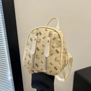 Mini beige backpack with cartoon bear print and front double zipper vertical pockets
