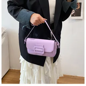 Detail of light purple baguette bag with smooth faux leather texture and tonal buckle