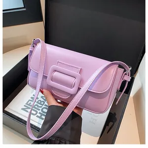 Detail shot of lilac purple baguette bag with glossy texture and large square buckle