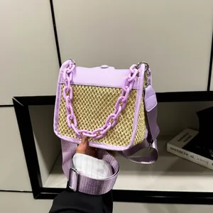 Detail of lavender woven straw bag with chunky purple chain and wide fabric strap