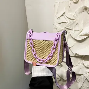 Detail of lavender PU leather and straw woven crossbody bag with chunky plastic chain