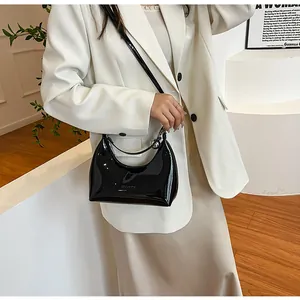 Sac hobo chic en cuir verni noir avec finition brillante et détail de chaîne argent