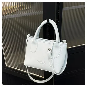 Detail of light blue lychee pattern leather tote bag with adjustable shoulder strap