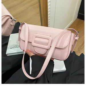 Close-up of a pink baguette bag with large square buckle and smooth leather finish
