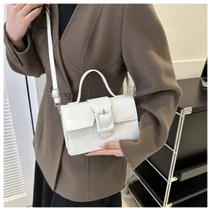 White PU leather handbag with square buckle shown on model in a stylish wool coat