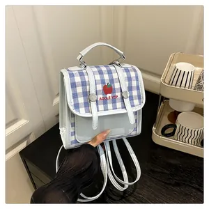 Close-up of blue gingham mini backpack with apple print and silver hardware detail