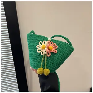 Detail of green woven cotton bag with 3D floral accents and elegant pearl button closure