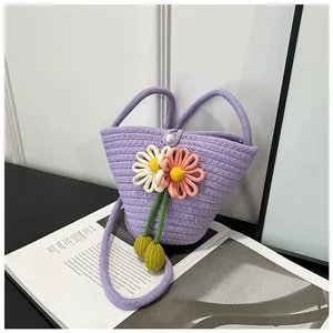 Detail of purple woven bucket bag with 3D crochet flowers and elegant pearl closure