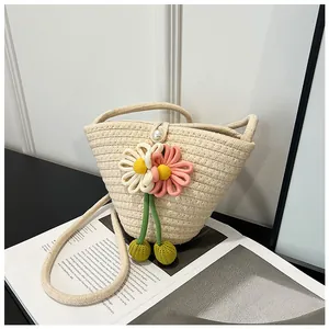 Detail of woven cotton rope beach bag with knit flower and pearl button closure
