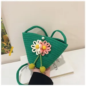 Detail of green hand-woven cotton rope bag with 3D flowers and pearl buckle closure