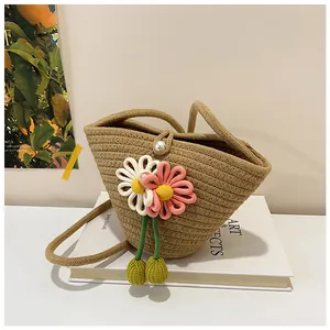 Detailed macro shot of the cotton woven bag featuring a pearl clasp and floral accents