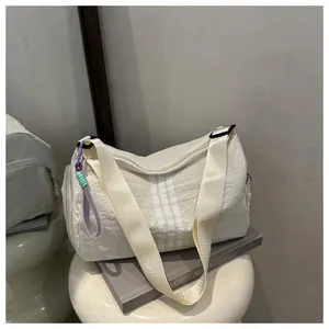 Close-up of cream yoga sports duffel bag showing soft nylon texture and striped detail