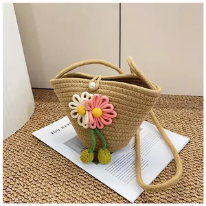 Detail of woven cotton bucket bag with 3D floral accents and pearl lock closure