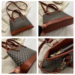 Detailed view of the vintage geometric pattern canvas and golden zipper on this small box bag