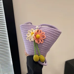 Handwoven purple cotton rope bucket bag with floral accents and a pearl snap closure