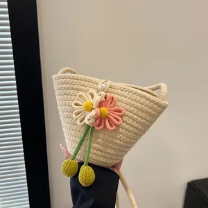 Handmade cream woven cotton rope bag with floral decor and pearl button for beach outings