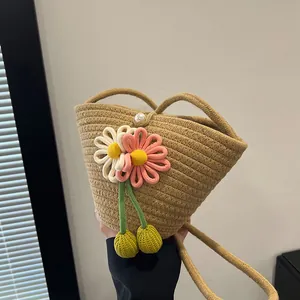 Handmade woven cotton rope bucket bag featuring floral crochet accents and pearl closure