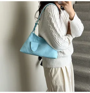 Detail of light blue woven texture on women's shoulder bag with fine craftsmanship