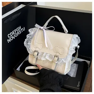 Detail of cream lace shoulder bag with cat-shaped buckles in a premium gift box