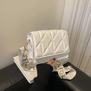 White quilted crossbody bag with stylish wide shoulder strap and gold-tone metal hardware