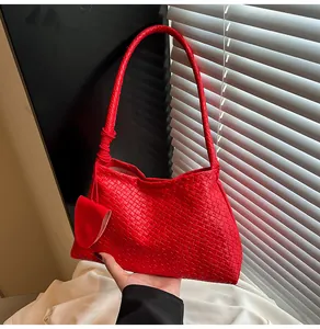 Detail of red woven texture on bucket bag with matching small coin purse charm